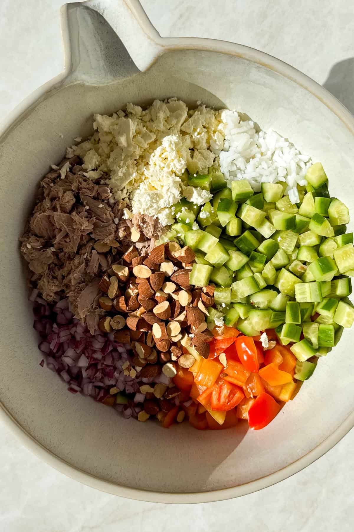 All of the salad ingredients in a bowl.
