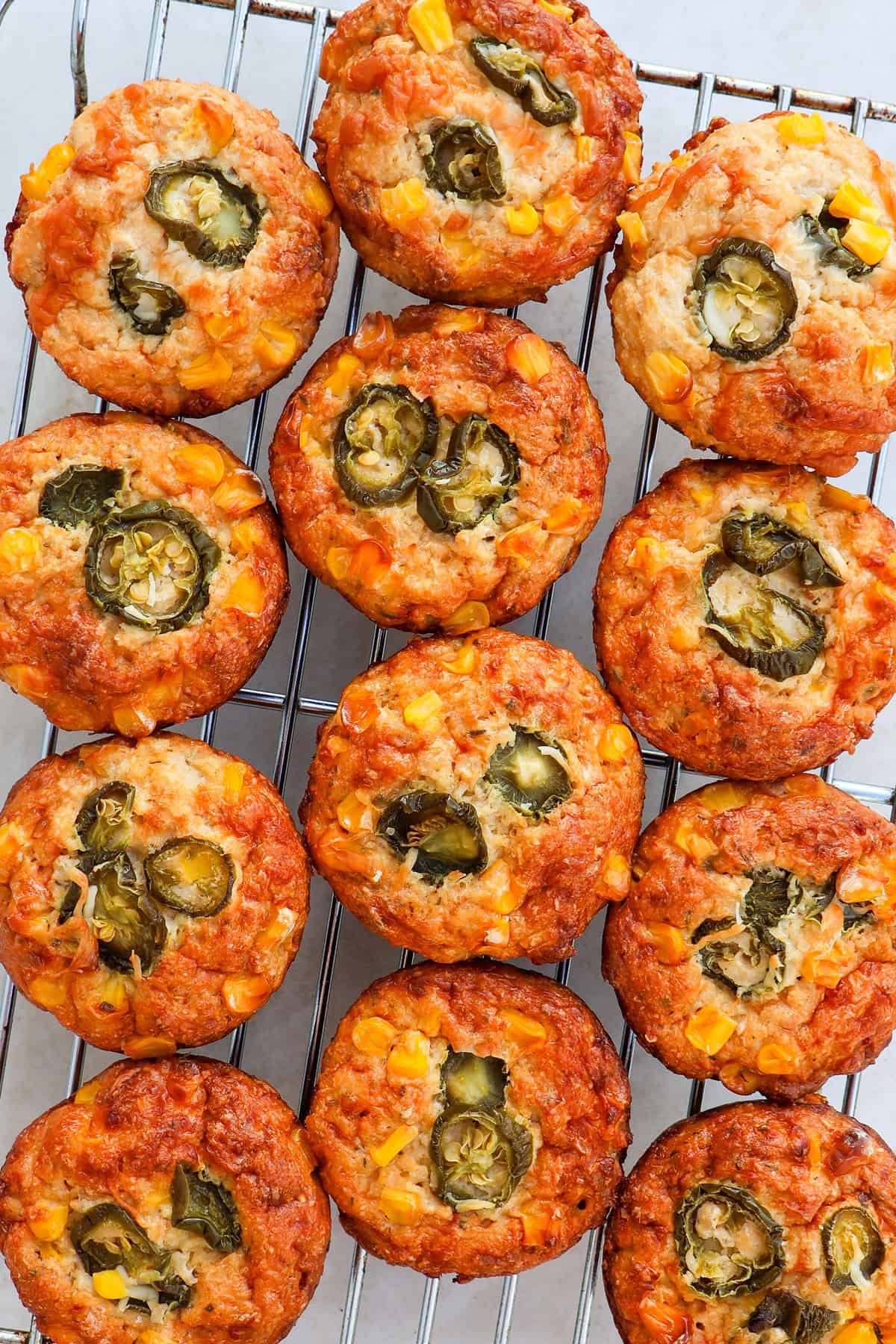Cauliflower corn muffins on a cooling rack.