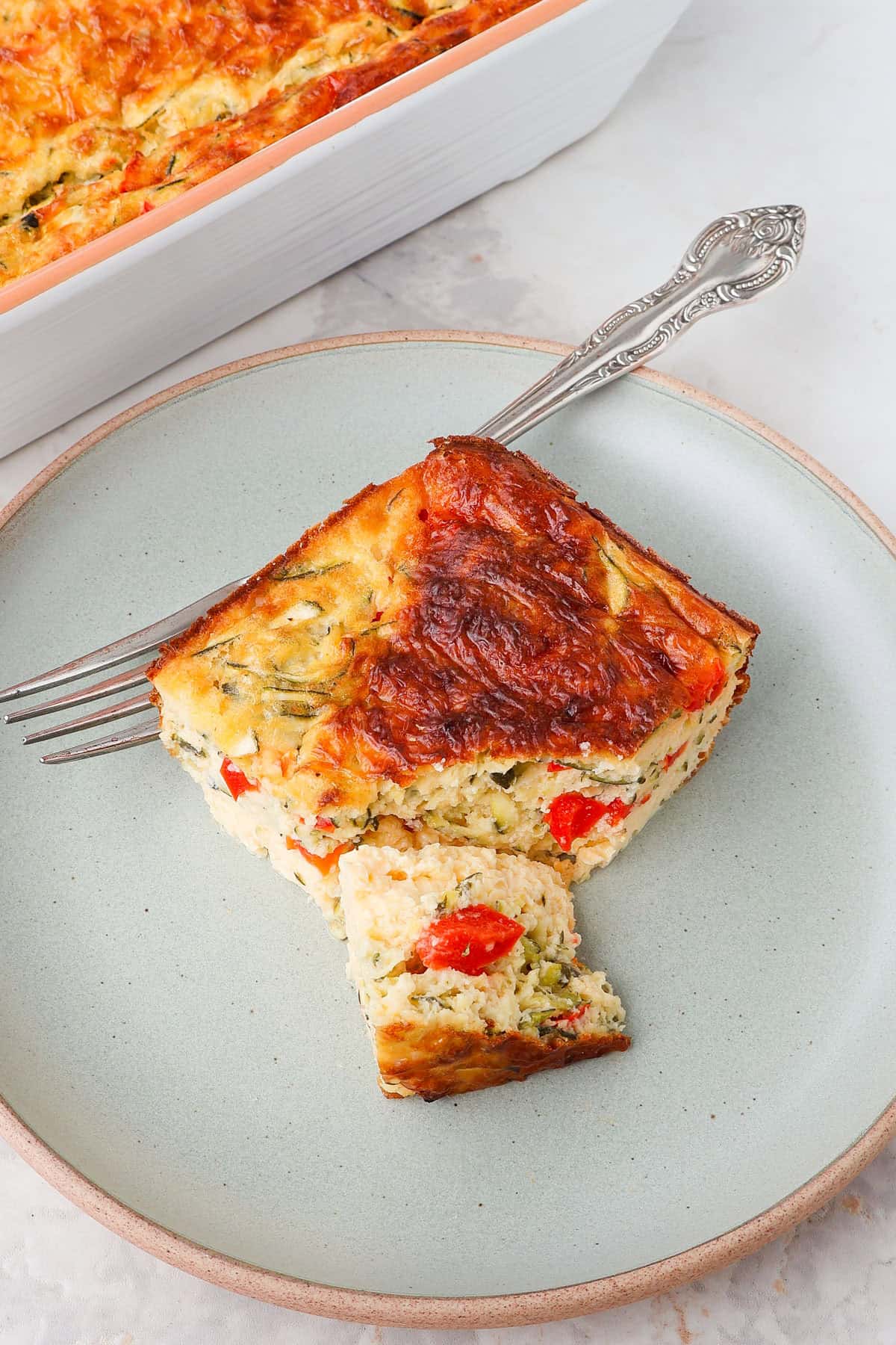 Side shot of the egg bake on a plate cut on the side.