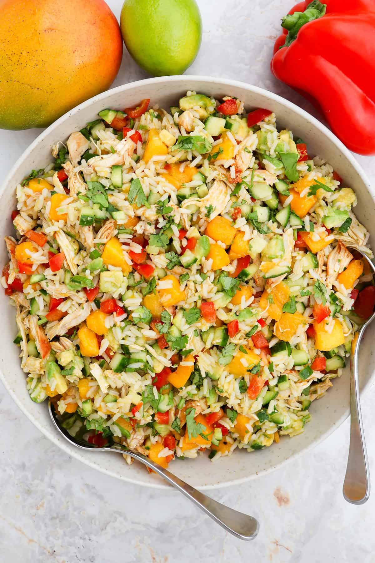 Mango salad served in a bowl with spoons.
