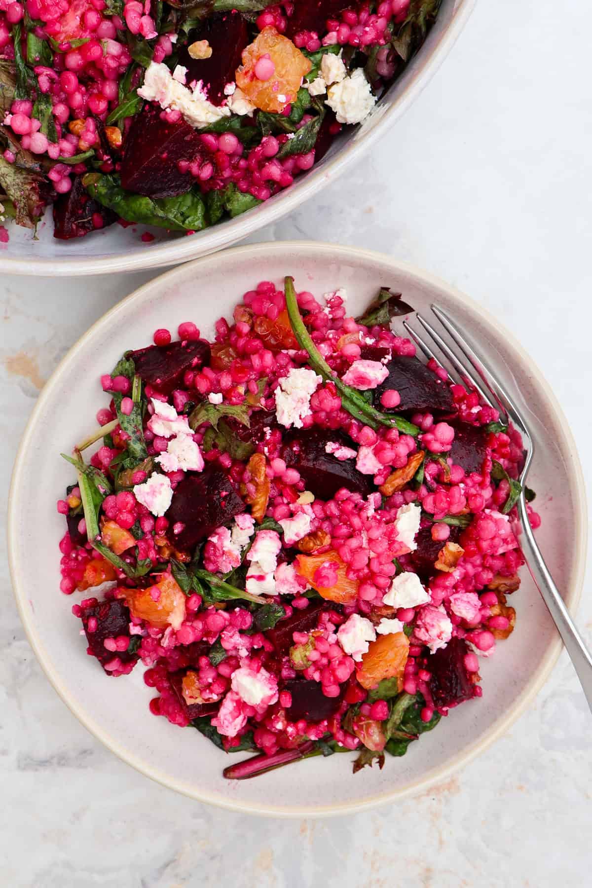 Beetroot salad served on a pate with a fork.