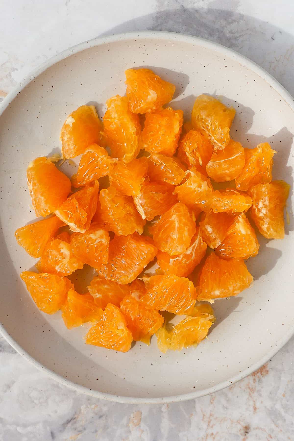 Orange segments on a plate.