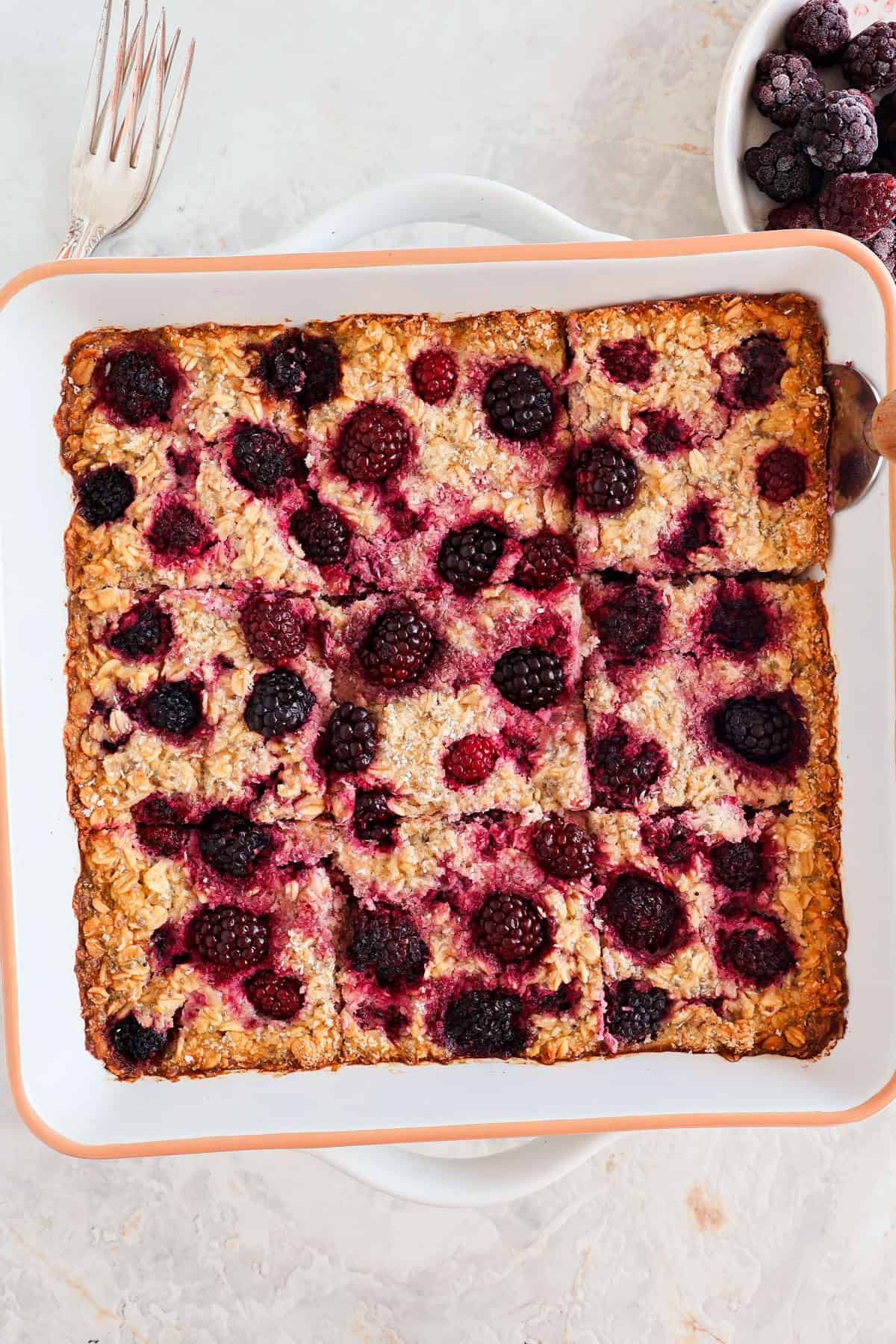 Blackberry baked oatmeal sliced up in the baking dish.