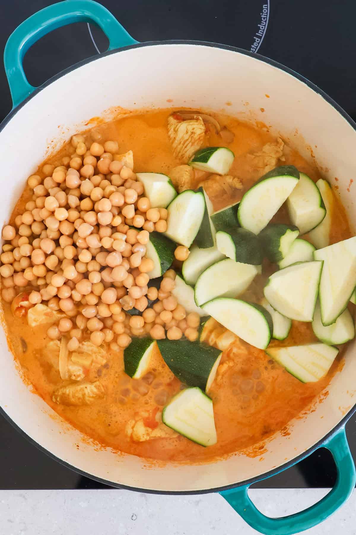 Chickpeas and zucchini added to the curry.